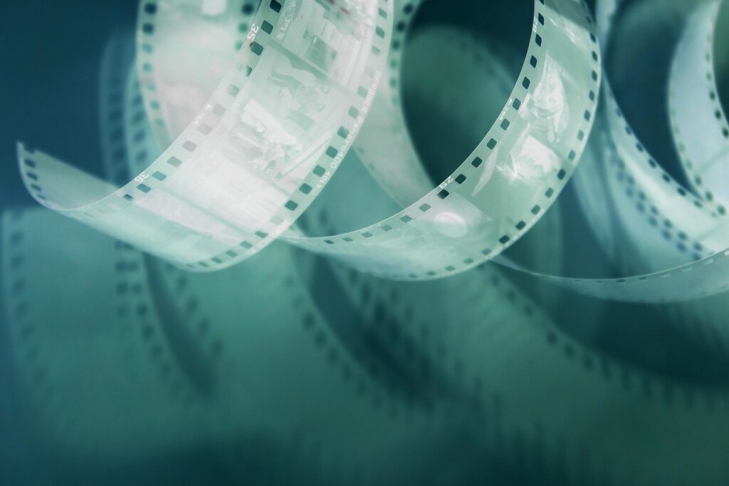 retro film, 35mm film, perforated, negative on pink background, with shadow, photo film, vintage film, film photography, analog film, vintage photography, retro photo