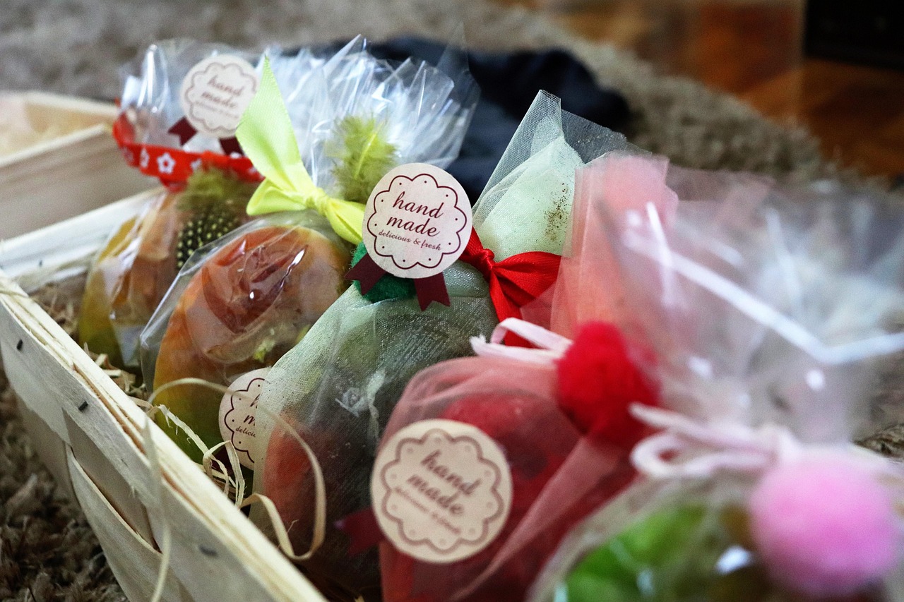 handmade soap, artisanal gift, craft packaging, bath gift, rustic basket, handmade label, diy gift, festive packaging, soap gift set, creative wrap, small business, natural beauty, eco packaging, colorful ribbons, mesh bag, handmade present, natural product, skincare gift, unique packaging, organic soap, cozy gift, handmade design, wrapped soap, self-care gift, beauty basket
